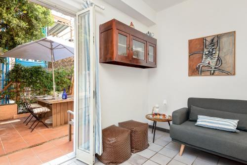 a living room with a couch and a sliding glass door at CasaSolemare Terrace seaview AC in Portovenere