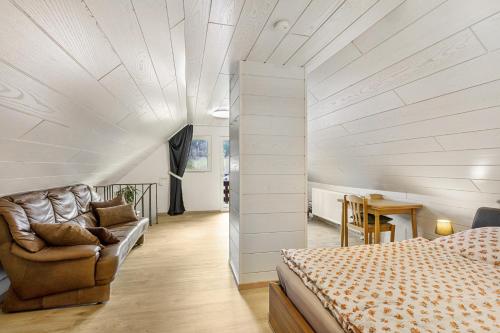 a bedroom with a bed and a couch and a table at Haus Waldesruh in Medebach