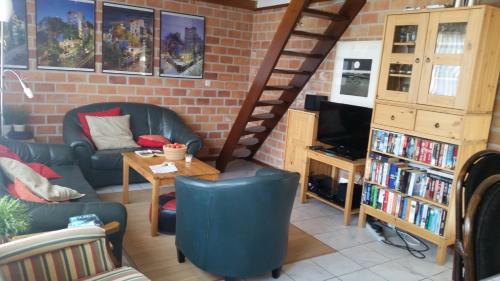a living room with a couch and a table at Die Muschelfinder in Sint Maartensvlotbrug
