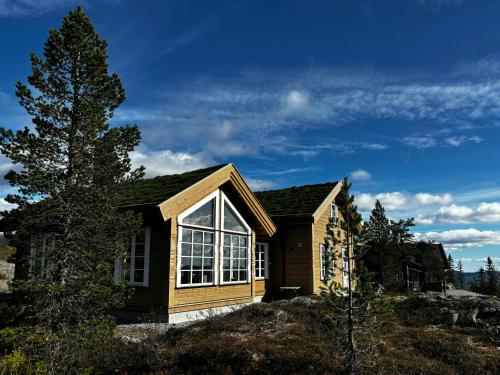 a small house on top of a hill at Mountain Cabin With Panoramic Views In Valdres in Bruflat