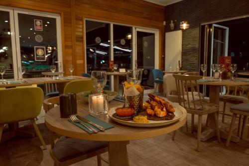a table in a restaurant with a plate of food at Landal Ullswater Heights in Great Blencow
