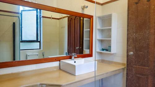 a bathroom with a sink and a mirror at Zahra Paradise in Mombasa