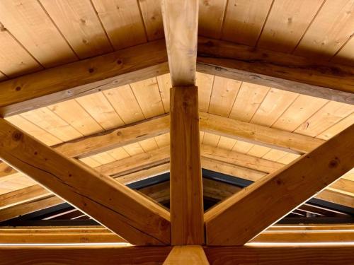a wooden ceiling of a building with wooden beams at Mountain Log Cabin in Mavrovo