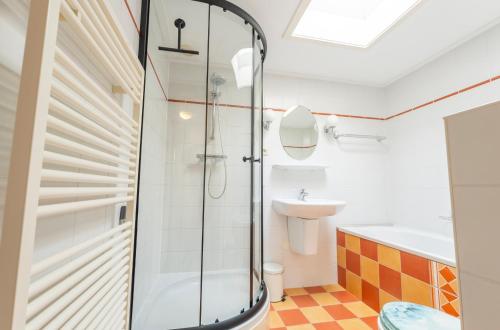 a bathroom with a shower and a sink at Golfvilla 38 in Hollum