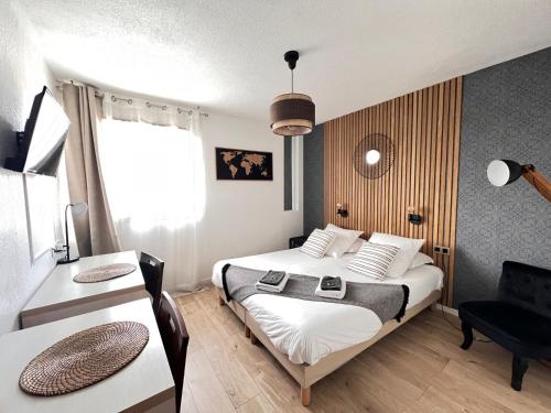 a hotel room with two beds and a desk at Appart'Hotel - Gare TGV - Courtine - Confluence - 407 bis in Avignon
