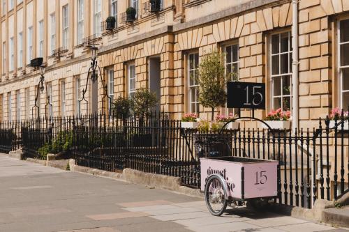 a bike parked on a sidewalk next to a building at No 15 by GuestHouse, Bath in Bath