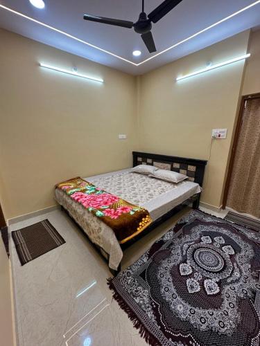 a bedroom with a bed and a large rug at Ahmed's Guest House in Hyderabad