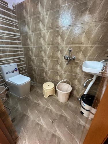 a bathroom with a toilet and a sink at Ahmed's Guest House in Hyderabad