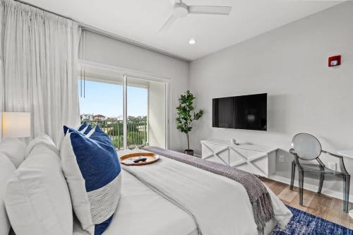 a bedroom with a bed and a large window at Inn at Seacrest Beach 409 in Inlet Beach