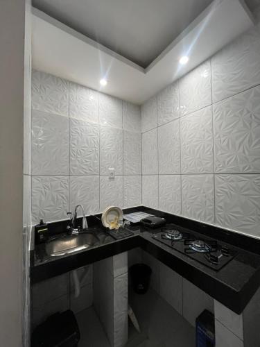 a bathroom with a sink and a counter top at Casa completa no centro de Belém in Belém