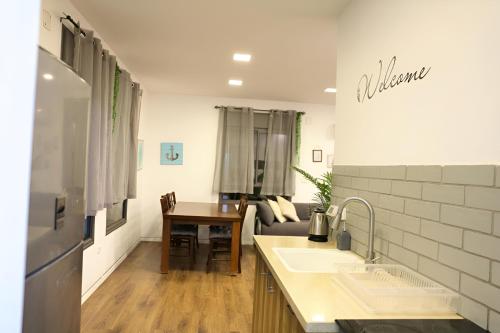 a kitchen with a couch and a table in a room at Suite Golan in Neot Golan