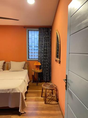 a bedroom with two beds and a window at The Urban Farm House in Accra
