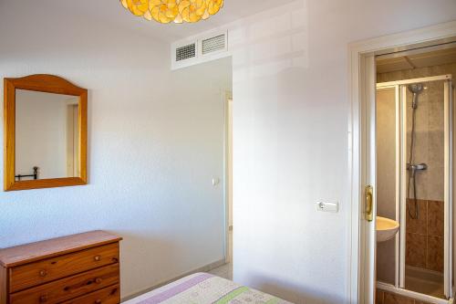 a bathroom with a bed and a mirror and a sink at Apartamentos Topacio Unitursa in Calpe