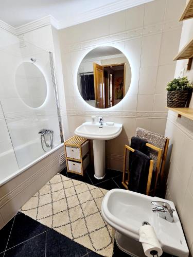 a bathroom with a sink and a tub and a mirror at Summertime in Porches