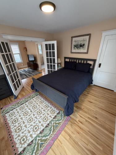 a bedroom with a large bed and a rug at The Coastal Connection in South Portland