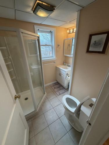 a bathroom with a toilet and a shower and a sink at The Coastal Connection in South Portland