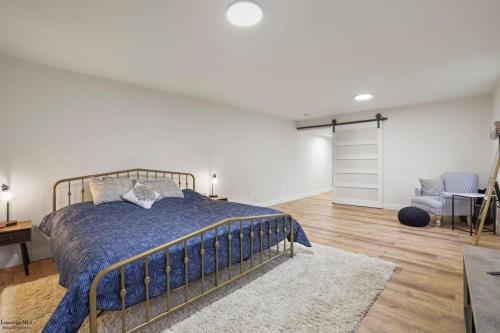 a bedroom with a bed with a blue bedspread at Corporate Cottage on Circle in Thornville