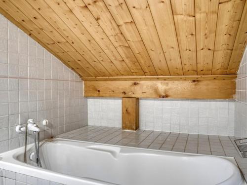 a bath tub in a bathroom with a wooden ceiling at Chalet à Megève, 4 chambres, proche centre, jardin, pour 10 pers. - Confort et services inclus - FR-1-453-1 in Megève