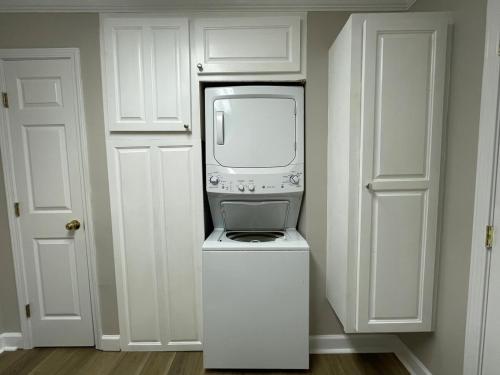 a microwave sitting on top of a machine in a kitchen at Deer Run Creek Cottage in Mountain City