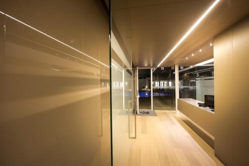a hallway with a glass door with a view of a building at Pietre Nere Resort & Spa in Modica