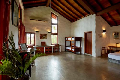 a large room with a bed and a desk at Bamboo Villa Kandy in Digana
