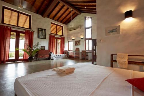 a bedroom with a large white bed in a room at Bamboo Villa Kandy in Digana