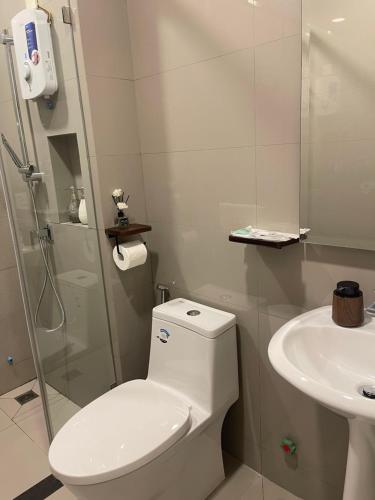 a white bathroom with a toilet and a sink at 22 Homestay-near AEON Mall 3 & Techo International Aiport in Ta Khmau