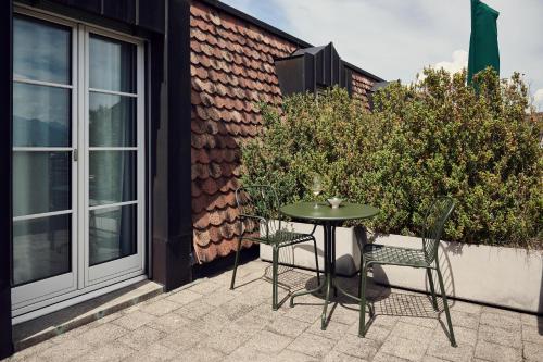 a patio with a table and chairs and a building at Sorell Boutique-Hotel Speer Rapperswil in Rapperswil-Jona