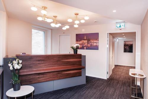 a waiting room at a salon with flowers on the counter at Sorell Hotel Rex Zürich in Zürich