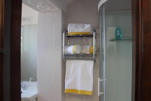 a bathroom with a towel rack with towels at Cascais Jasmim Doce in Cascais