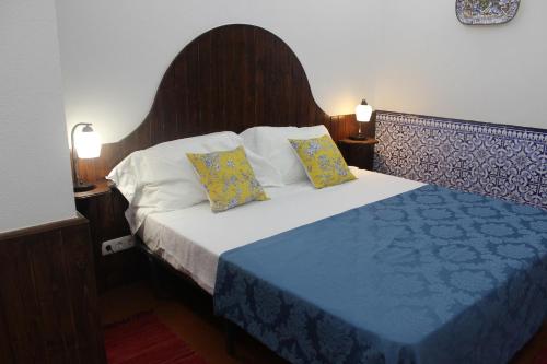 a bedroom with a large bed with two pillows at Cascais Jasmim Doce in Cascais