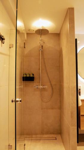 a shower with a glass door in a bathroom at B&B Natuurlijk Harderwijk in Harderwijk