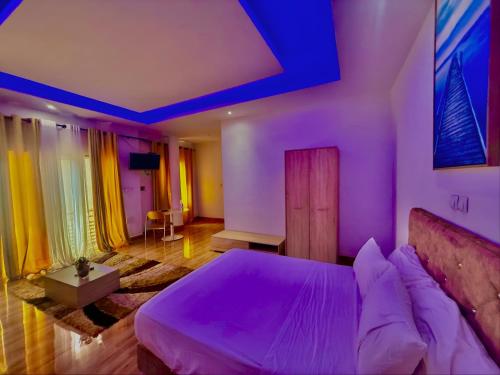 a bedroom with a bed with purple lights on it at AS Appartement meublé in Bamako