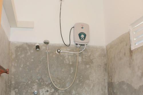 a shower in the corner of a bathroom at Shehara Sun Surf Lodge in Midigama