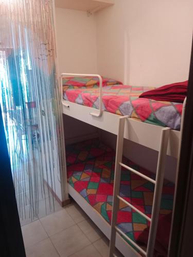 a small room with two bunk beds in it at Casa vacanza Roby in Lido dei Pini