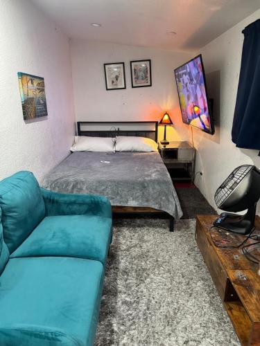 a bedroom with a bed and a couch at Tower District Hostel in Fresno
