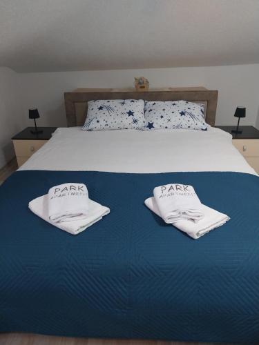 a bedroom with a bed with two towels on it at Park Apartment in Kochani