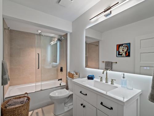 a bathroom with a sink and a toilet and a shower at Cleveland Escape - Hot Tub - Karaoke Machine - Sleeps 12 in Cleveland