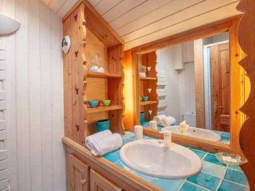 a bathroom with a sink and a tub and a mirror at Spacieux Duplex en Centre Station avec Balcon et Wi-Fi - FR-1-688-35 in Méribel