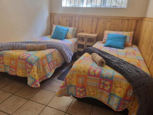 a room with two twin beds and a table at Ras Vill in Glencairn