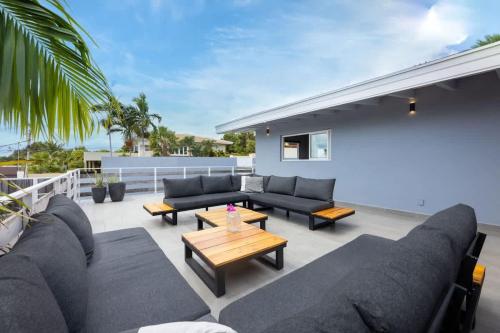 a patio with couches and a coffee table at Casa di Mama Villa with Private Pool in Jan Thiel