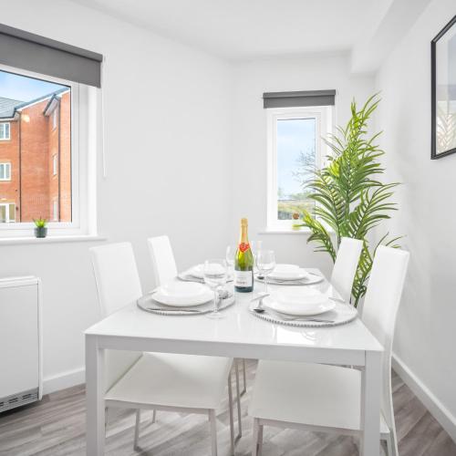 a white dining room with a white table and chairs at Modern Two Bed Apartment - Smart Tv - Wi-Fi - Parking 49C in Sleightholme