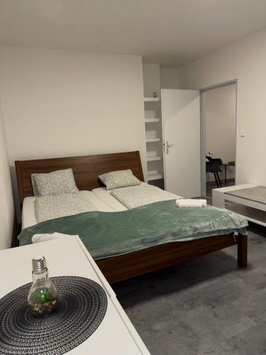 Un dormitorio con 2 camas y una mesa con una botella. en Útulný byt v blízkosti centra, en Juliánov