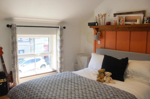 two teddy bears sitting on a bed in a bedroom at Blarney Street in Cork