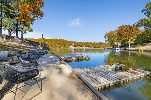 a row of chairs sitting next to a river at Heron House-ON Lake Avalon - near MTB in Bella Vista