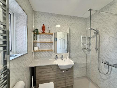 a bathroom with a sink and a shower at SubLyme in Lyme Regis