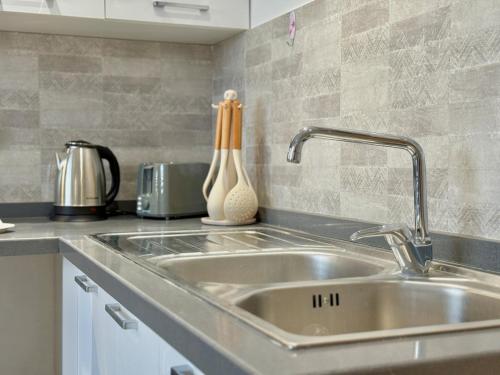 a kitchen counter with a sink in a kitchen at Residence The Green in Tunis