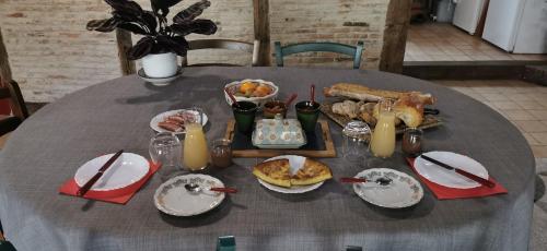 a table with plates of food and drinks on it at Carpe Diem in Saint-Savin-sur-Gartempe