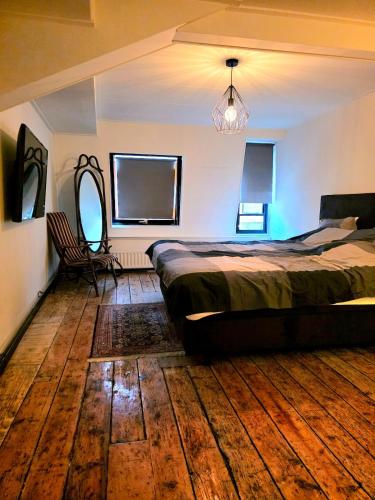 a bedroom with a bed and a chair in it at Homely 2Bedroom in the Center of Eindhoven in Eindhoven