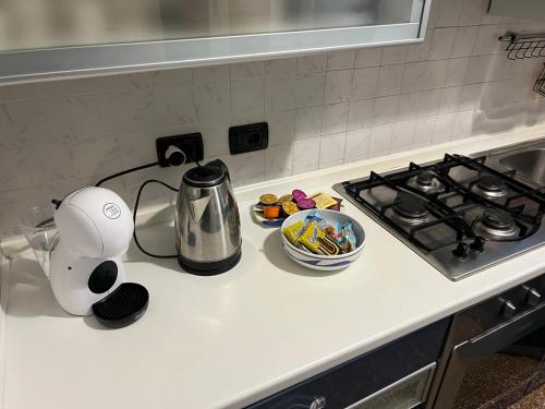 a kitchen counter top with a tea kettle and a stove at Angelo Home in Genova